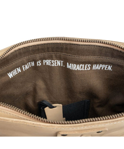 Interior view of the inside quote that reads: "When Faith Is Present, Miracles Happen." above the concealed carry pocket 