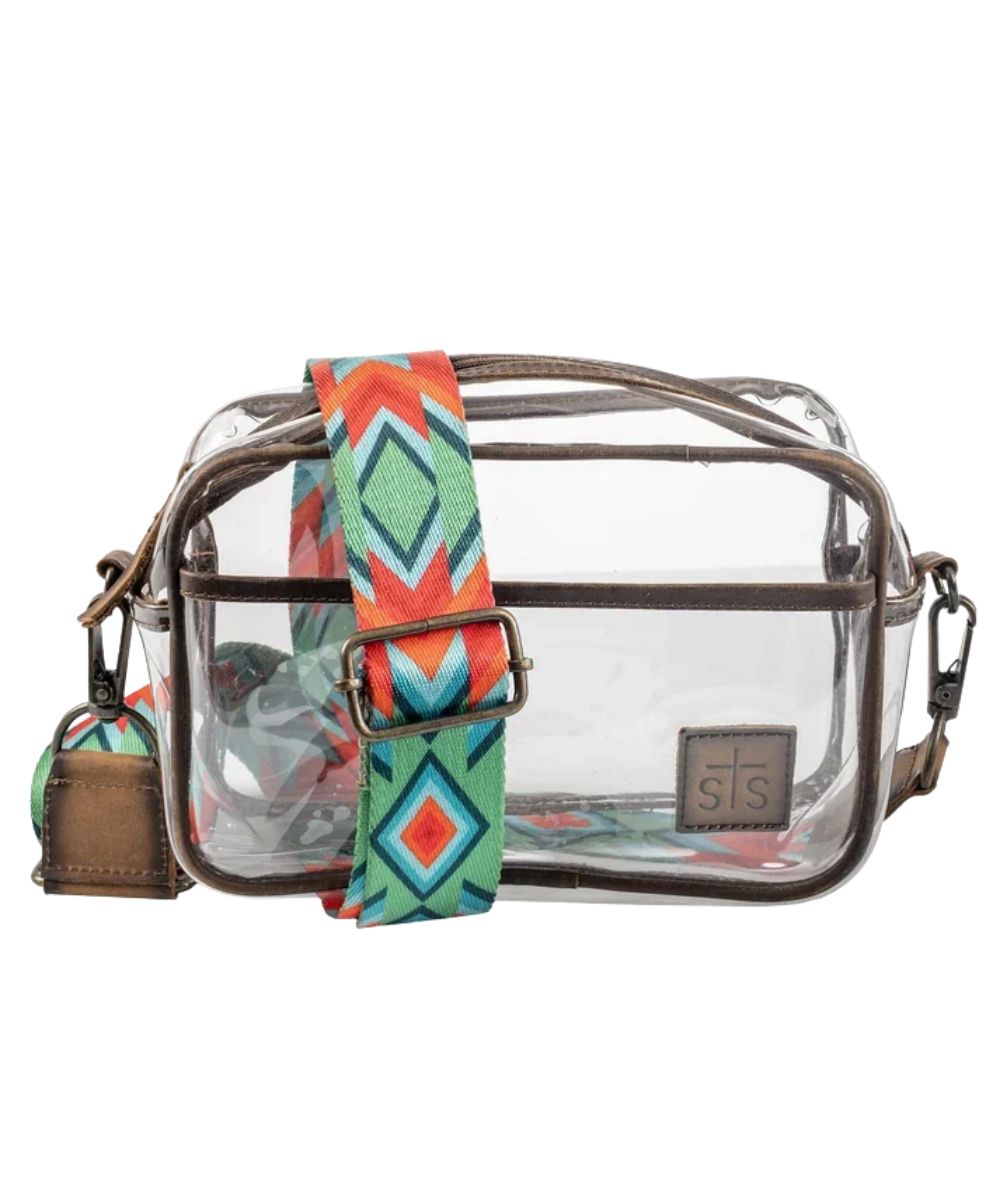 Front view of the women's clear STS Stadium Rules Lucy Crossbody Bag featuring the clear vinyl construction, dual zipper compartments, and the removable/adjustable printed nylon crossbody strap