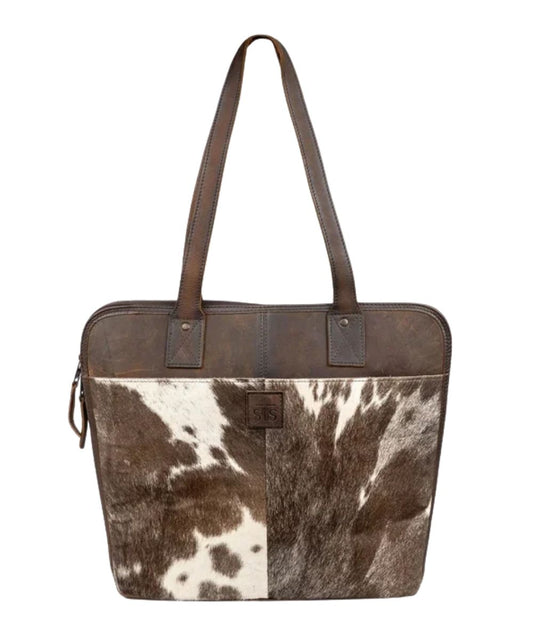 Front view of the women's dark brown STS Cowhide Laptop Shopper Bag featuring the dual leather carry handles, STS logo patch, and hair-on-hide front