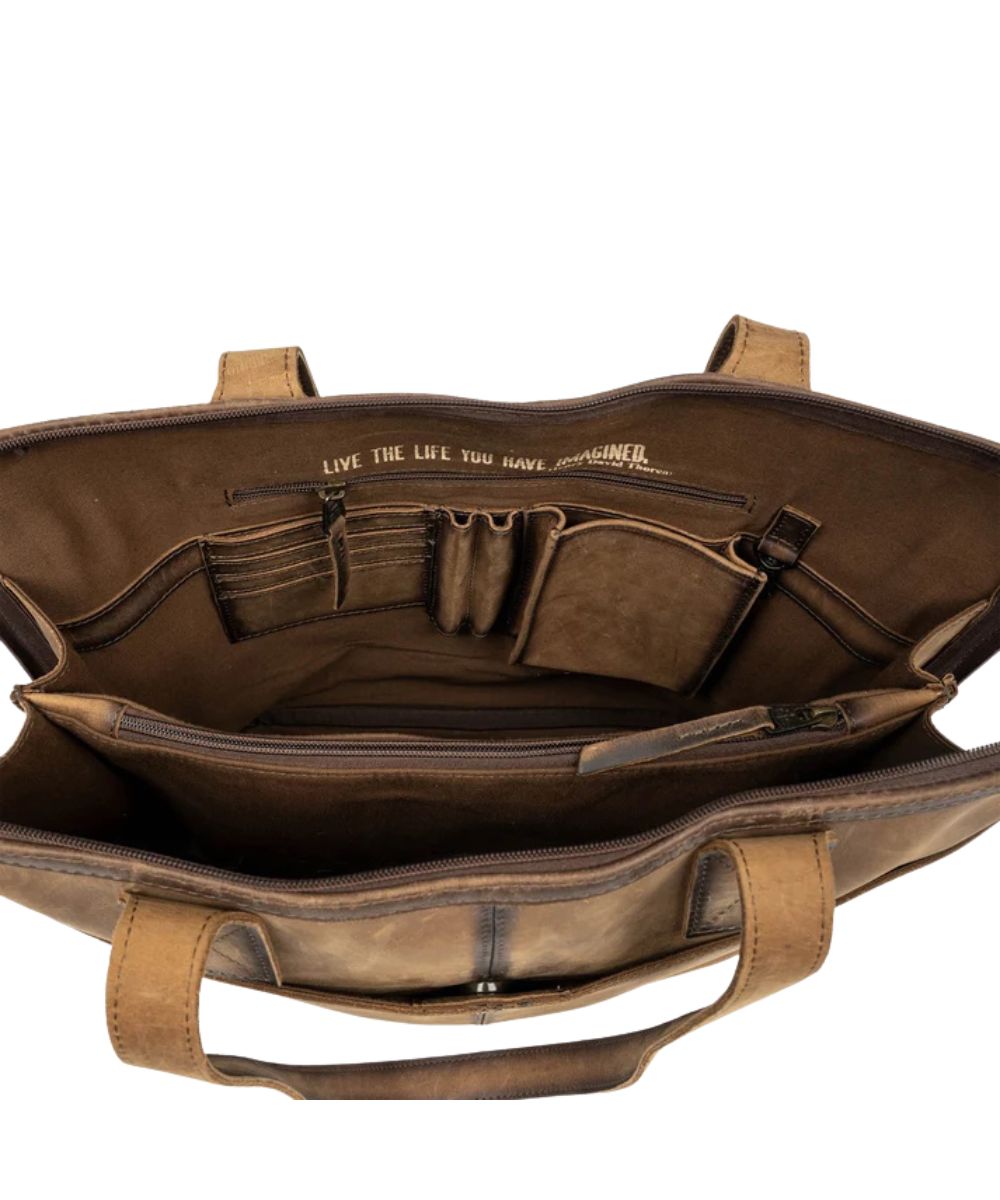 Interior view of the women's cowhide bag featuring the zip-around closure, card slots, pen slots, interior zip divider pocket, slip pocket, and a quote that reads: "Live The Life You Imagined."