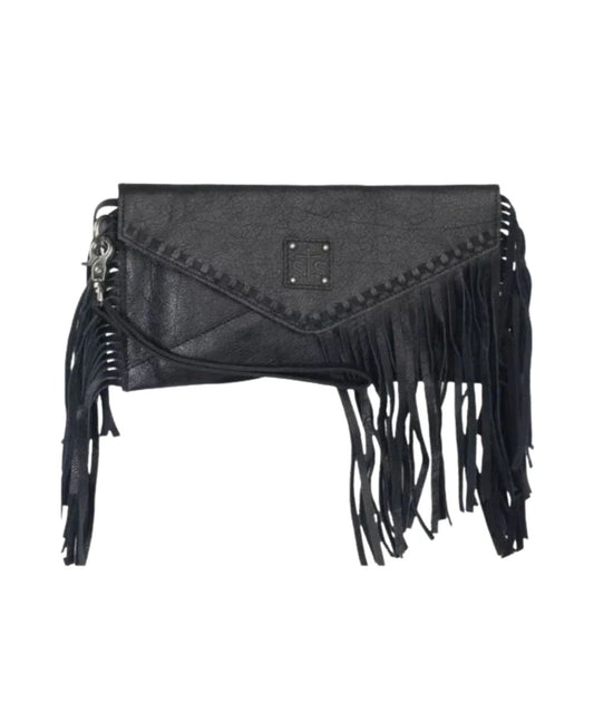 Front view of the women's black STS Indie Clutch featuring the removable wristlet strap, leather fringe, whipstitch details, STS logo patch, and magnetic fold closure