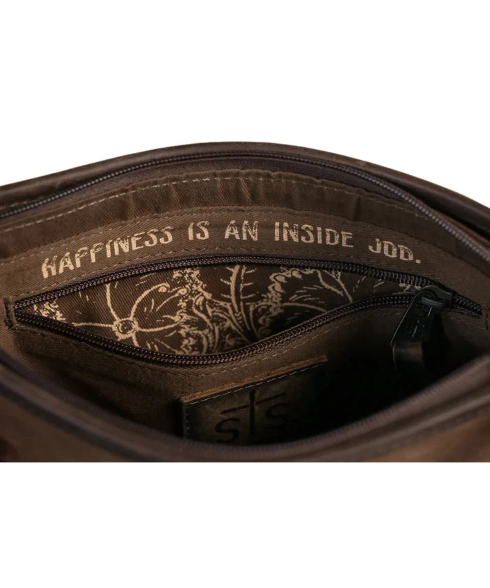 Close-up interior view of the zip closure compartment featuring the interior zip pocket with an inside quote above it that reads: "Happiness Is An Inside Job."
