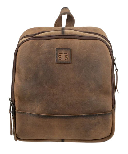 Front view of the brown leather STS Baroness Mini Backpack featuring the STS branded leather patch, top leather carry handle, and the zip-around closure