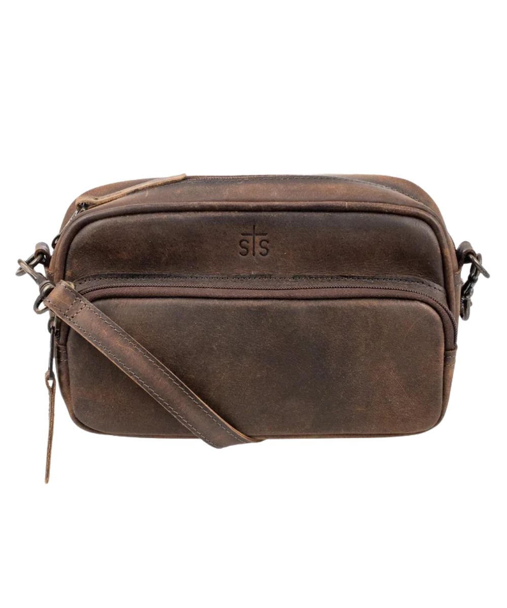 Front view of the women's brown STS Baroness Jess Crossbody featuring the STS branded leather, front zipper pocket, and an adjustable/removable leather crossbody strap