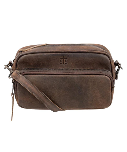 Front view of the women's brown STS Baroness Jess Crossbody featuring the STS branded leather, front zipper pocket, and an adjustable/removable leather crossbody strap