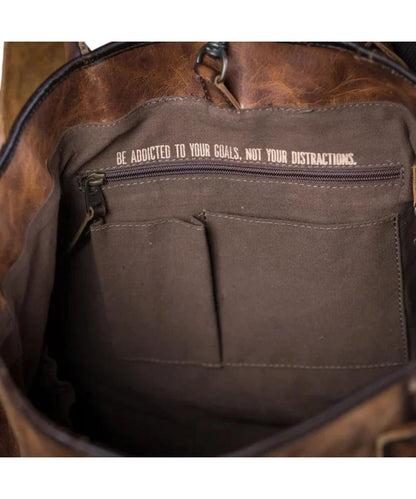 Interior view of the tote featuring the 2 slip pockets, zipper pocket, keychain clasp, and a quote that reads: "Be Addicted To Your Goals, Not Your Distractions."