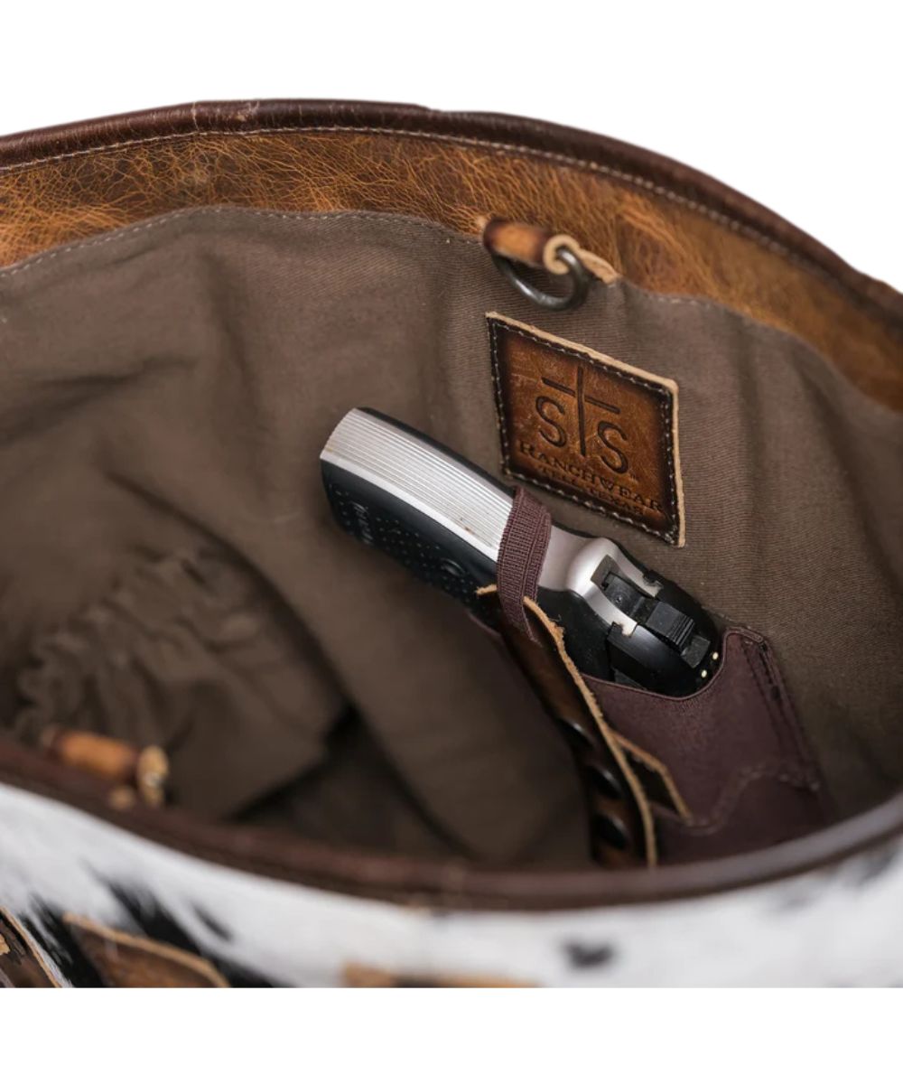 Interior view of the women's cowhide tote featuring the interior concealed carry, keychain clasp, and scrunch pockets
