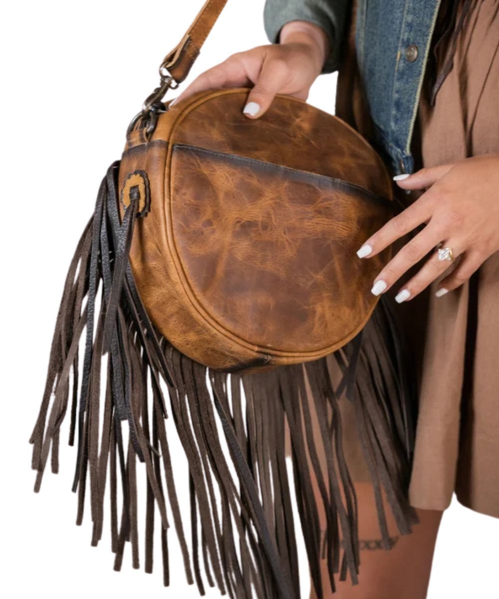 Back view of the women's brown leather crossbody purse featuring the exterior back magnetic slip pocket