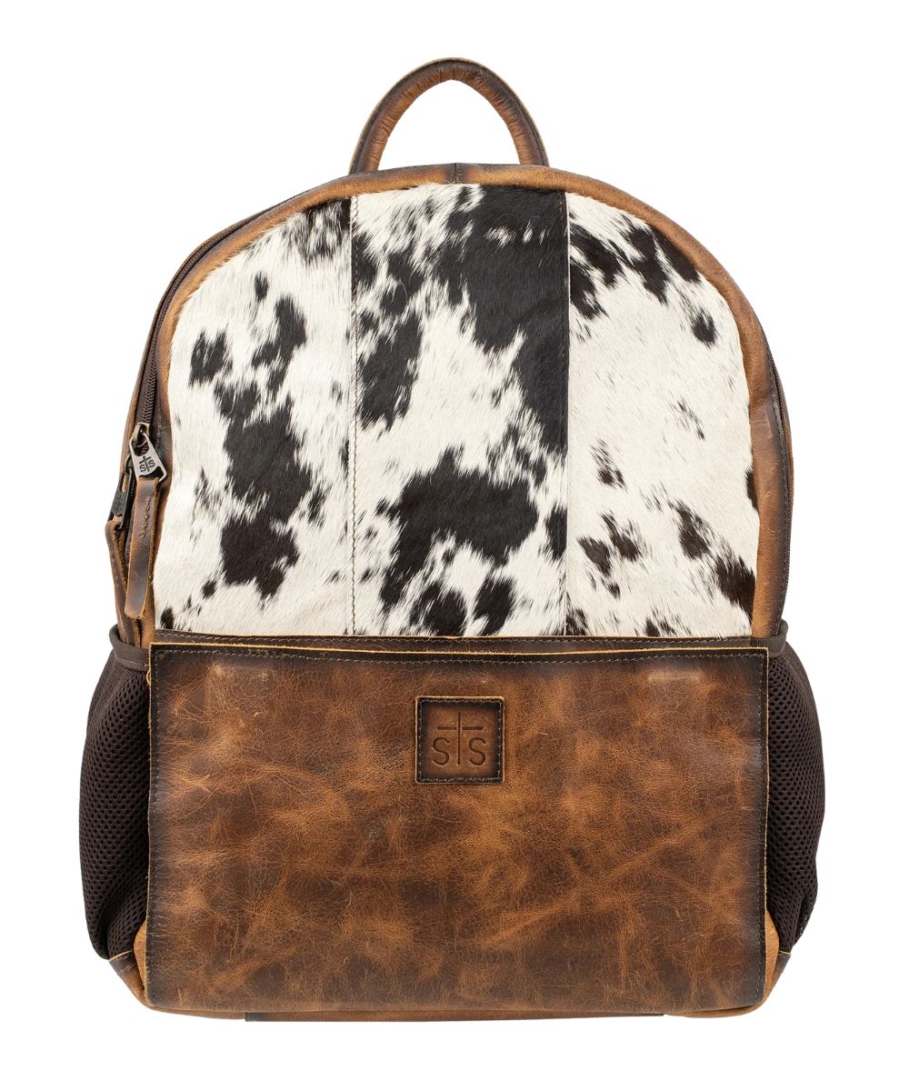 Front view of the Guadalupe Cowhide Valley Backpack featuring the top leather carry handle, side mesh pockets, and front magnetic pocket