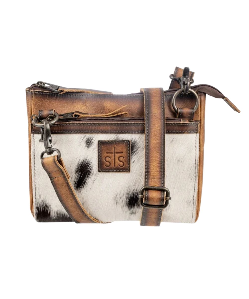 Front view of the women's brown STS Guadalupe Cowhide Lily Crossbody featuring the hair-on-hide front, front zipper pocket, zipper closure on main compartment, and a removable/adjustable leather crossbody strap