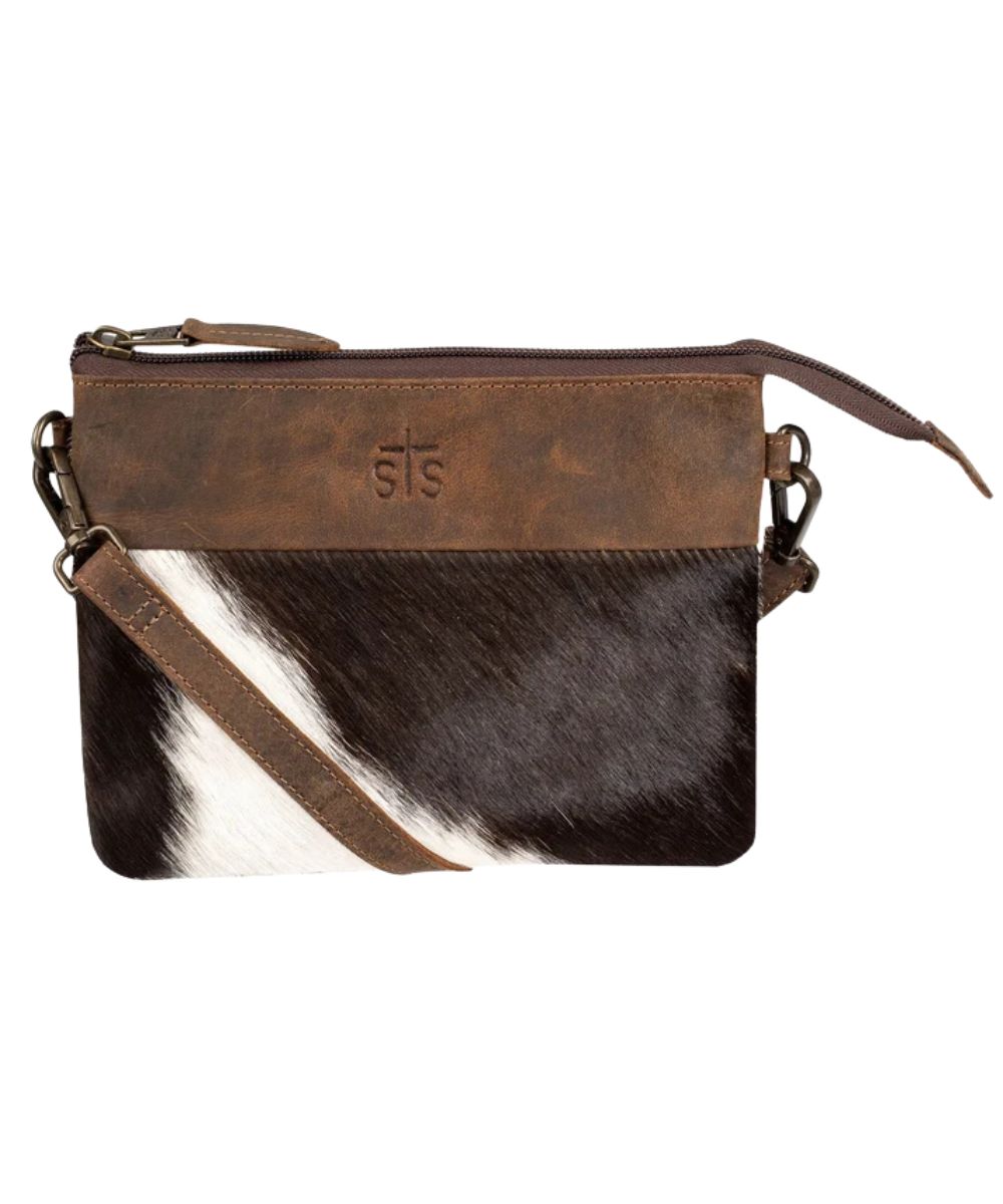 Front view of the women's dark brown STS Cowhide Rio Crossbody featuring the hair-on-hide leather front, removable/adjustable leather crossbody strap, STS stamped leather, and top zipper closure