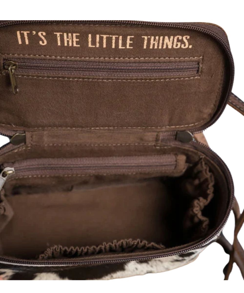 Interior view featuring a single compartment with 3 scrunch pockets, 2 zip pockets, this bag also comes with a removable/adjustable leather crossbody strap