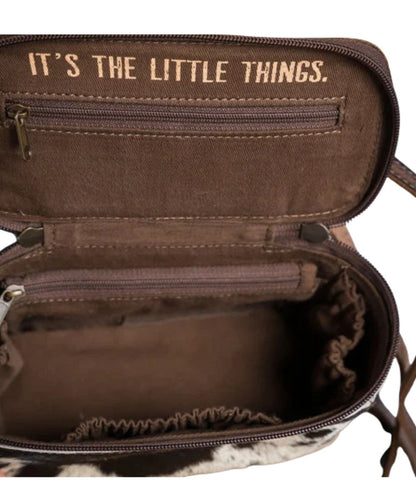 Interior view featuring a single compartment with 3 scrunch pockets, 2 zip pockets, this bag also comes with a removable/adjustable leather crossbody strap