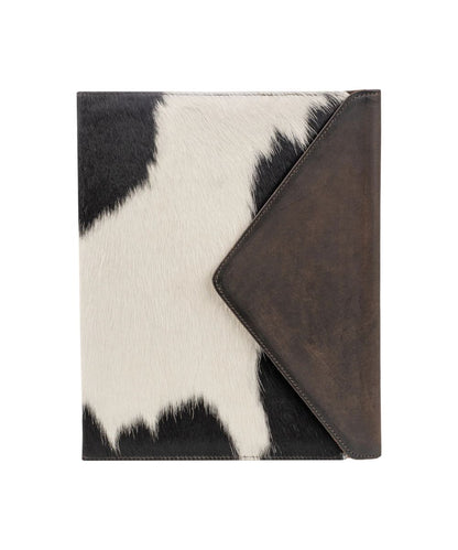 A folio-style case with a black and white cowhide pattern on the front and a dark brown envelope flap, shown on a plain white background.
