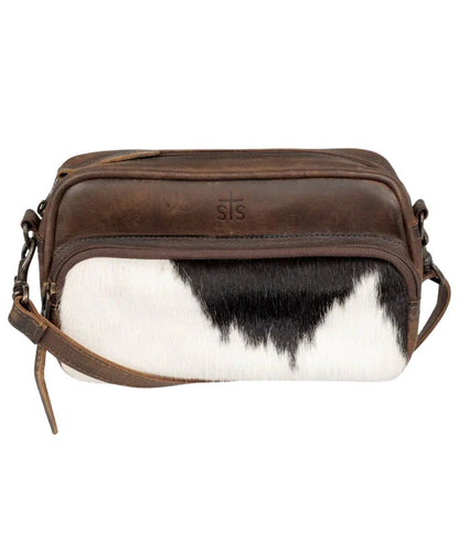 Front view of the women's dark brown STS Cowhide Jess Crossbody featuring the hair-on-hide front zipper pouch, STS stamped leather, top-zipper closure, and a removable/adjustable crossbody strap