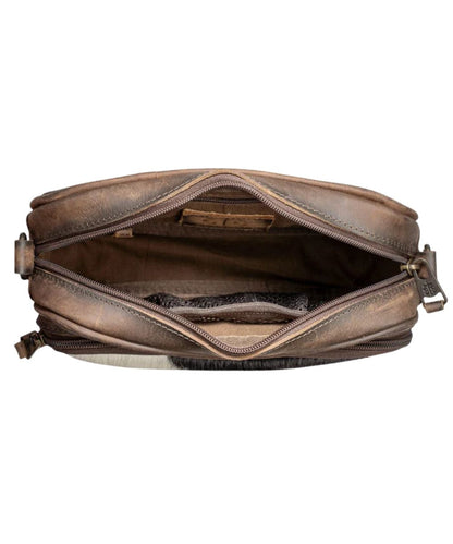 Interior view of the women's crossbody featuring the interior zip pocket and a mesh scrunch pocket
