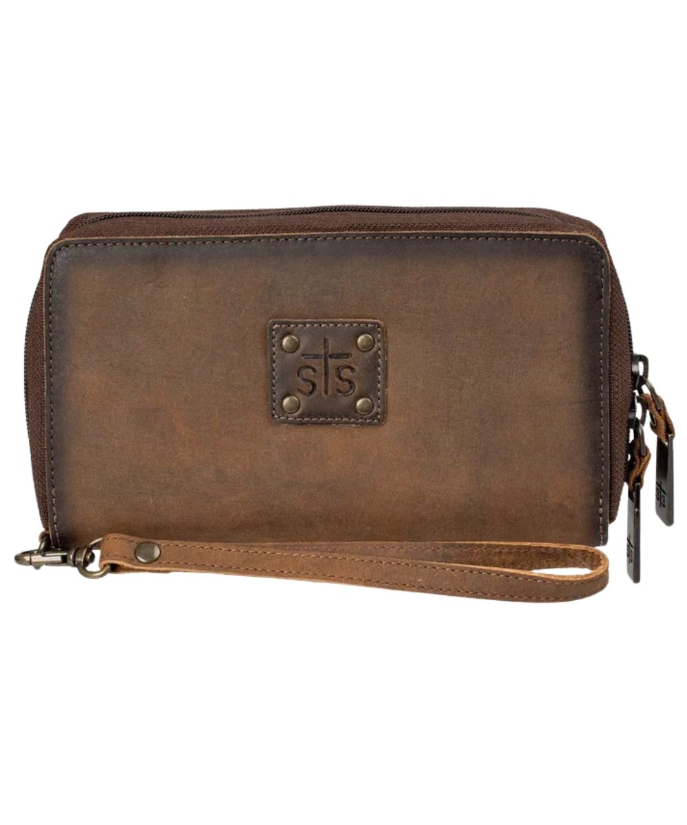 Front view of the women's brown STS Baroness Kacy Organizer featuring the STS branded leather patch with metal studs, zip-around closure, and a removable leather wristlet strap