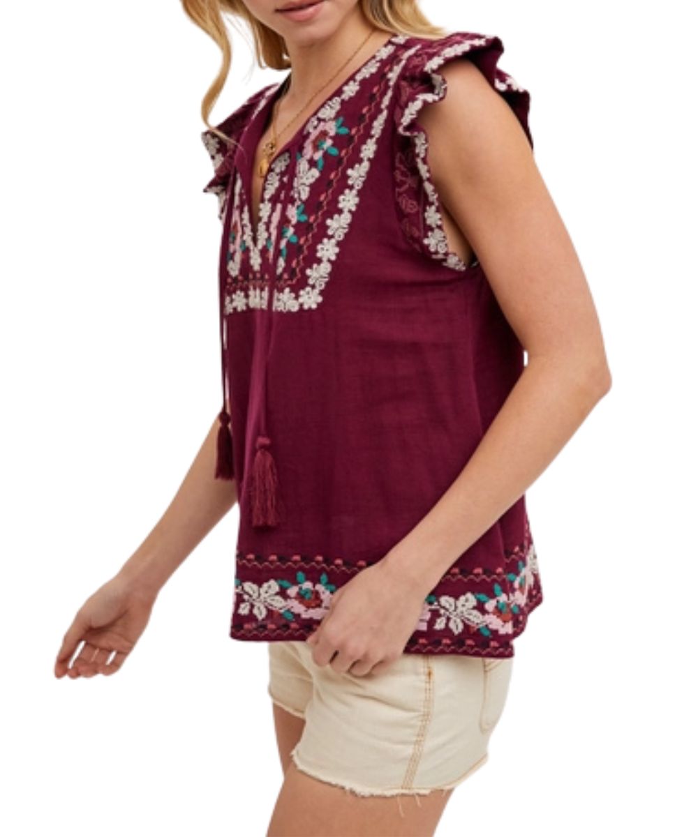 Side view of the women's plum boho top featuring short ruffle sleeves