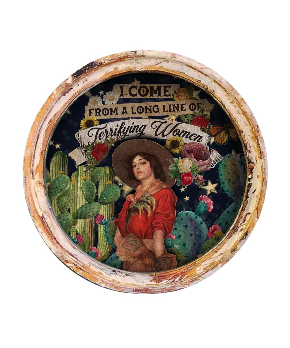 Large framed circle artwork design reads: "I come from a long line of terrifying women"