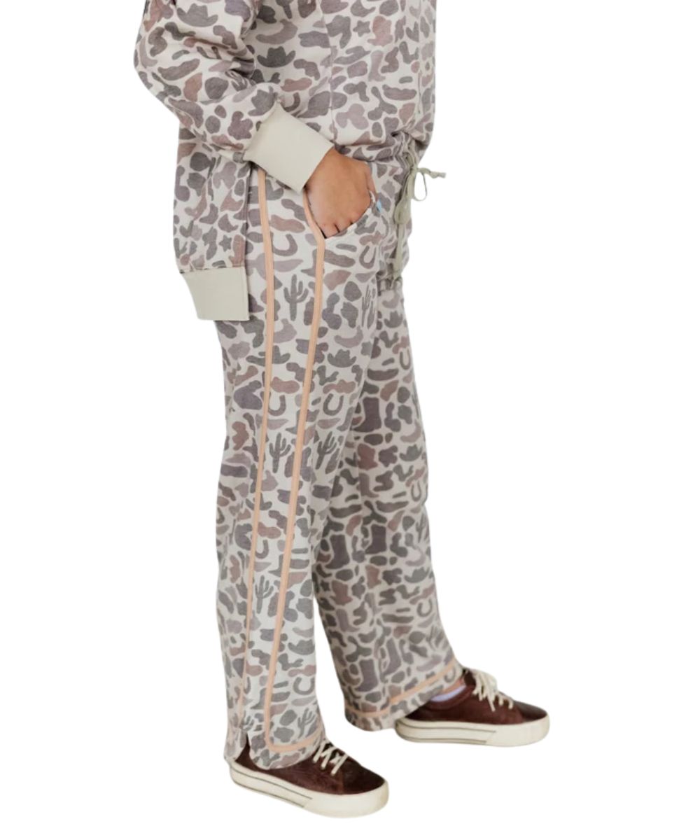 Side view of the women's camo sweatpants featuring the side hand pockets and tonal contrast binding along the outer seams and hem