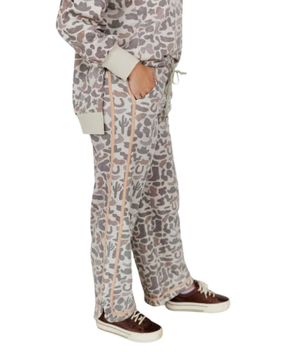Side view of the women's camo sweatpants featuring the side hand pockets and tonal contrast binding along the outer seams and hem
