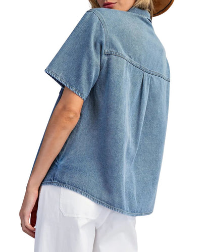 Back view of the women's short sleeve denim blouse featuring the straight back yoke and box pleat