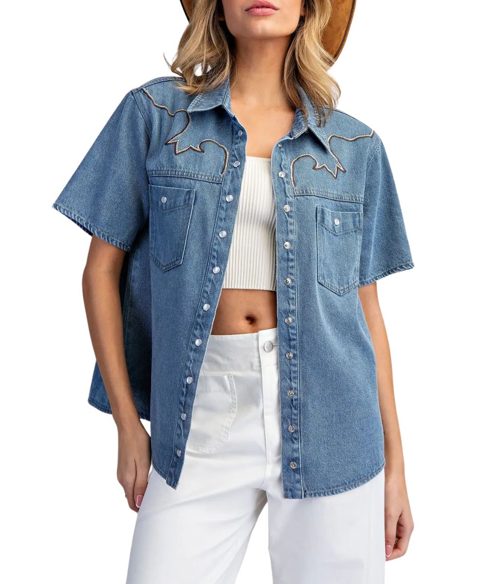 Front view of the women's blue denim short sleeve snap blouse featuring the western embroidered front yokes