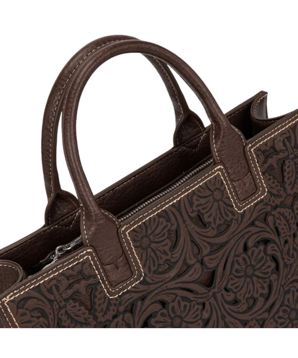 dark brown satchel purse with floral tooled design and intricate cutouts and matching handles