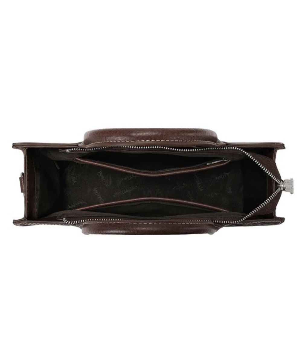 top down view of the interior of a dark brown satchel purse with floral tooled design and intricate cutouts