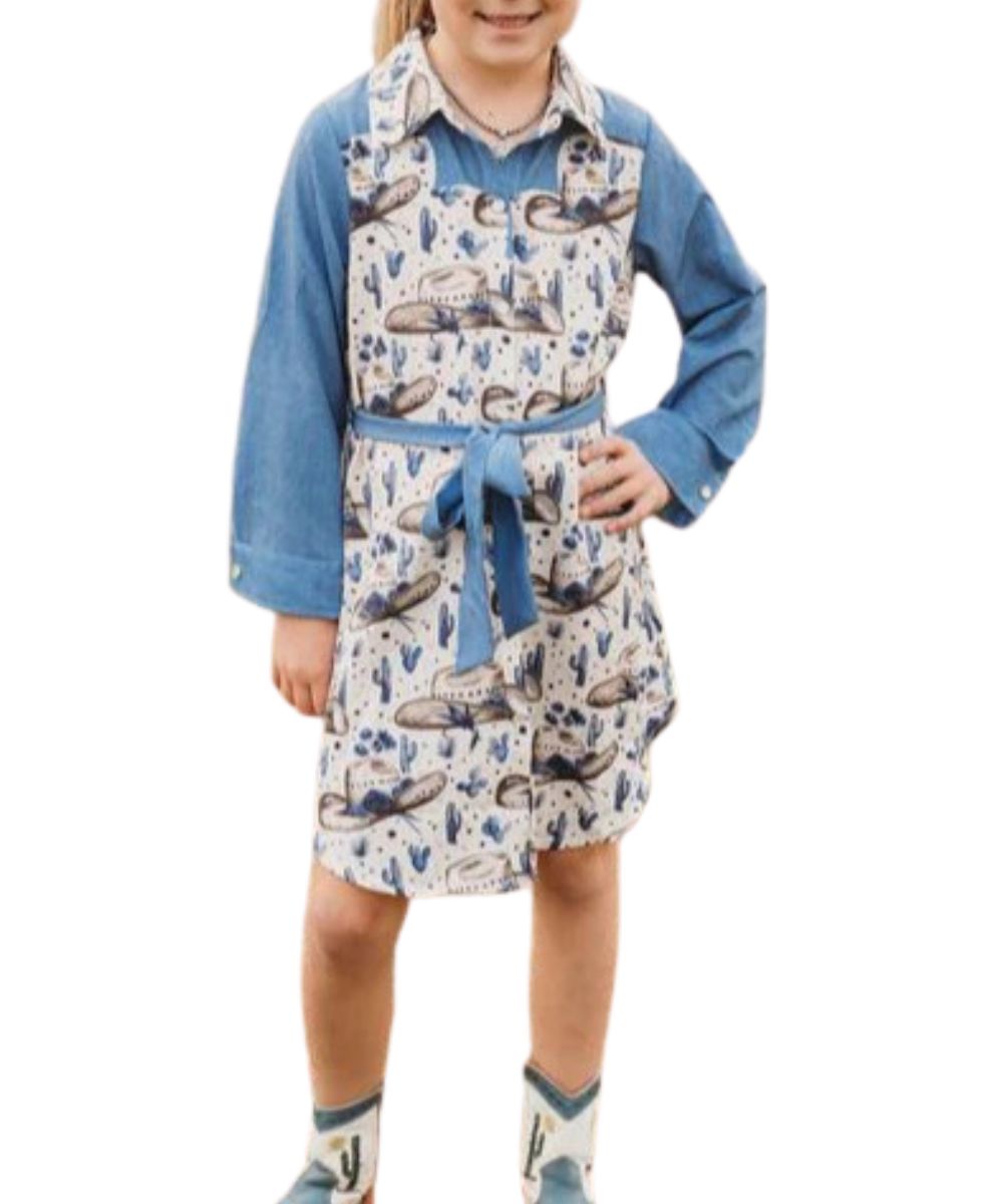 Front view of the girl's long sleeve pearl snap dress featuring a white cowgirl hat/cactus printed body and blue denim sleeves
