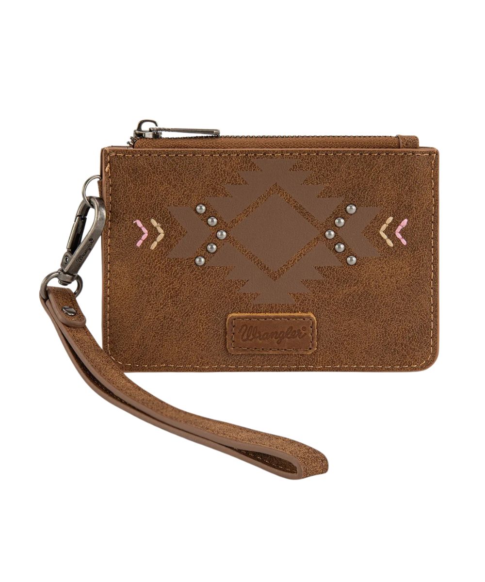 Front view of the women's brown faux leather Wrangler wristlet card case wallet featuring the aztec design on the front with silver studs and pink accents, Wrangler logo patch, and removable wristlet strap