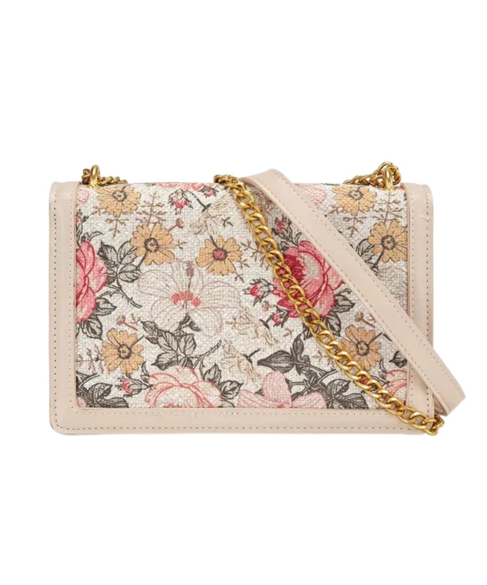 Back view of the women's tan floral crossbody bag featuring the floral canvas and gold chain strap