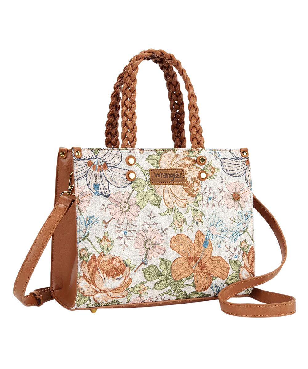 Right angled view of the women's brown floral handbag featuring a removable/adjustable crossbody strap and metal feet on the bottom for protection and stability