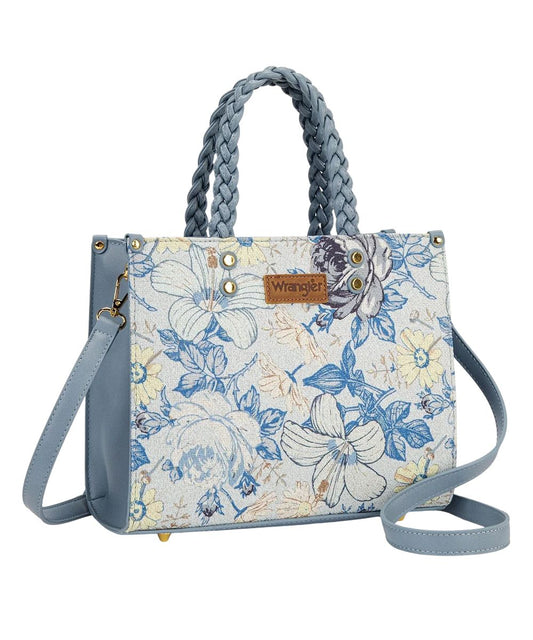 Front view of the women's light blue jean Wrangler Tote Bag featuring the Wrangler logo applique on the front, braided top carry handles, and floral print on white canvas
