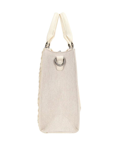 Side view of the women's tan denim tote/crossbody bag featuring a removable/adjustable crossbody strap and top carry handles