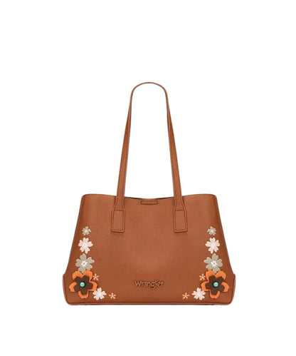 A brown leather tote bag by Wrangler, featuring embroidered floral patterns in orange, white, and light green on the lower corners, with the Wrangler logo printed in gold on the front.