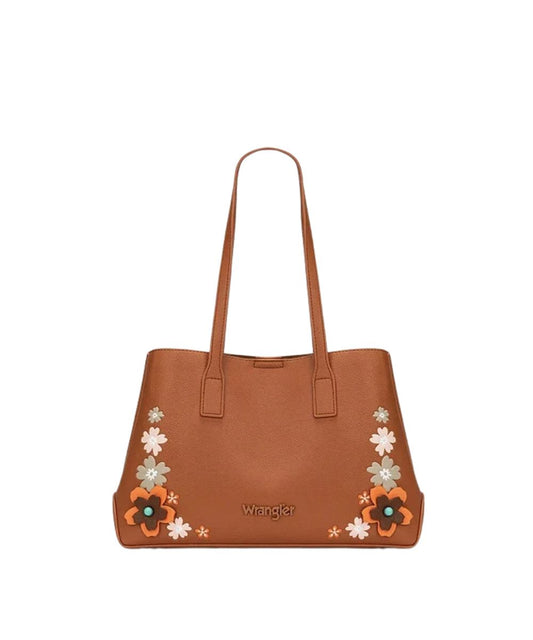 A brown leather tote bag by Wrangler, featuring embroidered floral patterns in orange, white, and light green on the lower corners, with the Wrangler logo printed in gold on the front.