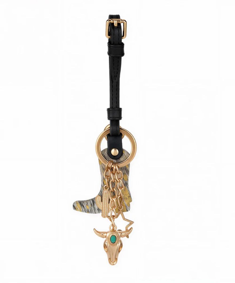 black and gold bag charm on a white background