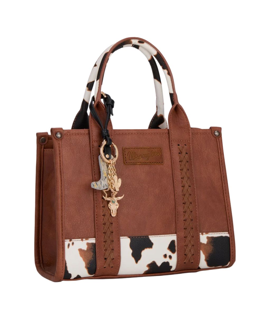 black and gold bag charm on a brown purse on a white background