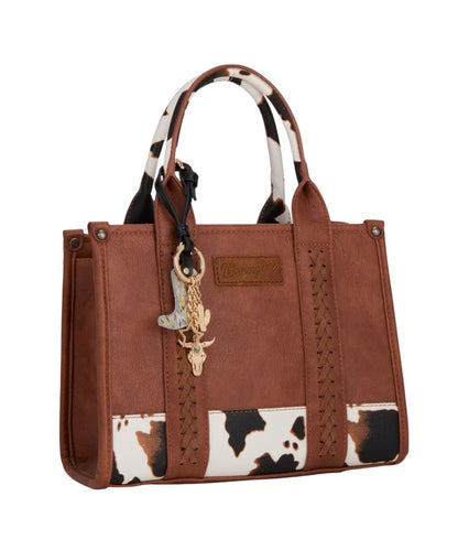 black and gold bag charm on a brown purse on a white background