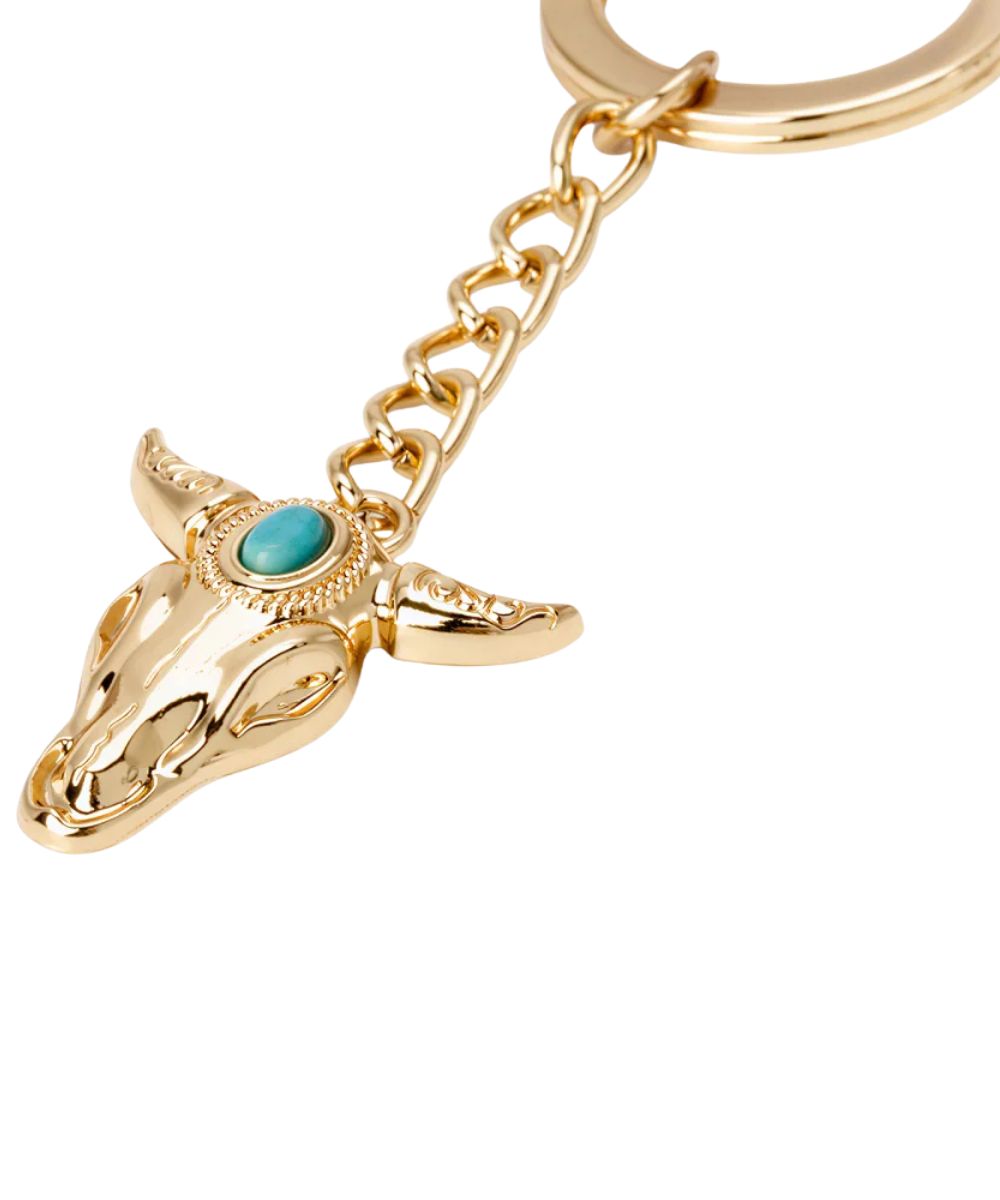 Gold keychain with a bull head design and turquoise stone on a white background