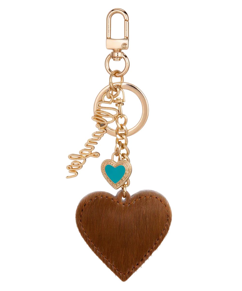 Side view of the brown hair-on-hide heart bag charm featuring a gold-tone metal chain