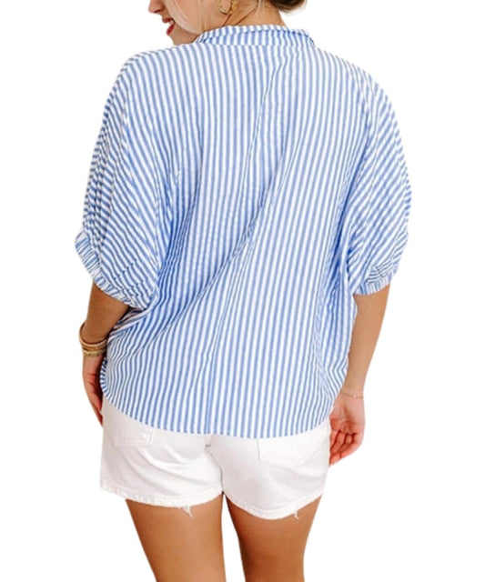 Back view of the women's sky blue striped blouse featuring the short puff sleeves and relaxed fit