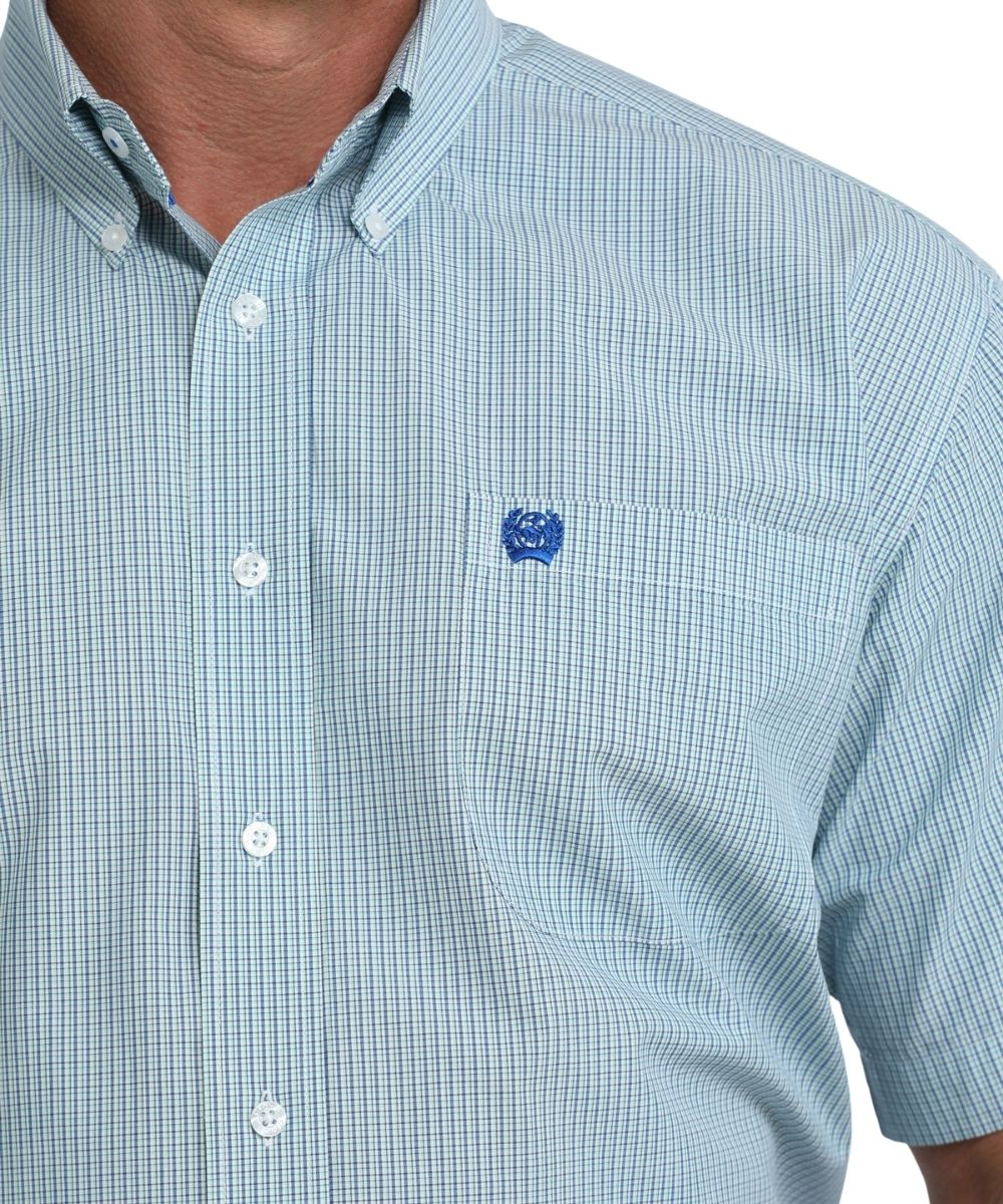 close up view of button down collar and of single chest pocket with blue embroidered Cinch logo